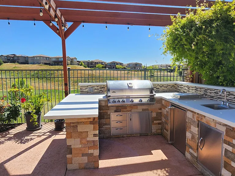 Backyard outdoor kitchen. Kitchen faucet and mini refrigerator.