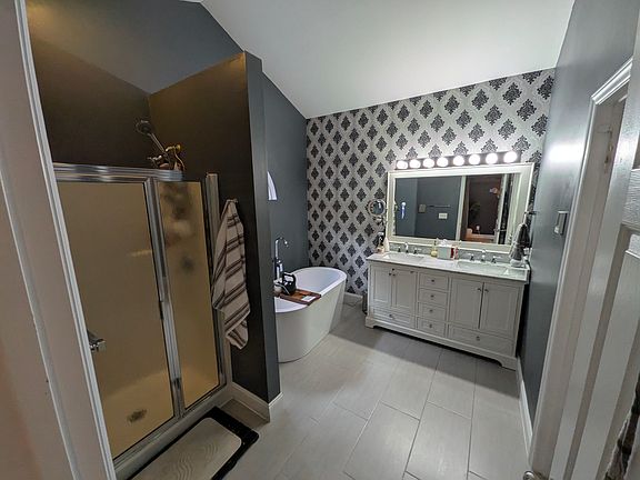 Private Primary Bathroom
A spacious primary bathroom featuring both a freestanding soaking tub and a separate walk-in shower. The double-sink vanity provides ample space, while a separate toilet room adds privacy and functionality.