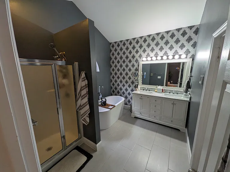 Private Primary Bathroom
A spacious primary bathroom featuring both a freestanding soaking tub and a separate walk-in shower. The double-sink vanity provides ample space, while a separate toilet room adds privacy and functionality.