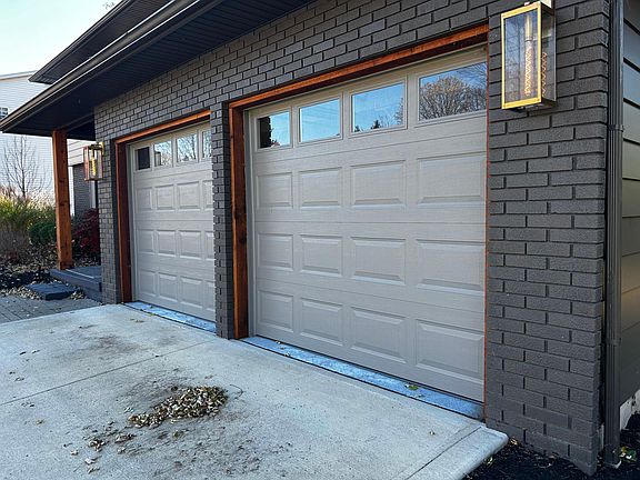 Custom accent lighting. New garage doors w cedar trim