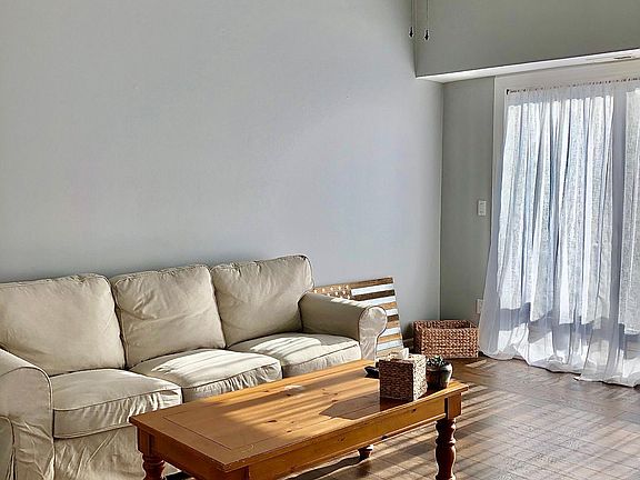 View of living room to sliding door, accessing balcony