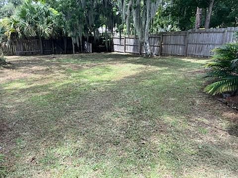 Fenced on 3 sides. Chicken coop/garden platform in the back corner of yard. Huge tree keeps the area cool.