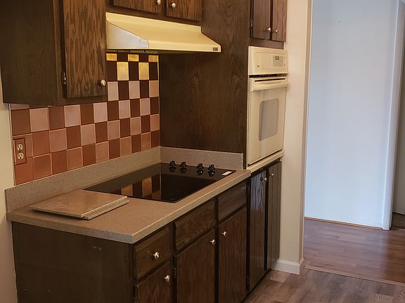 Kitchen with copper tile backsplash