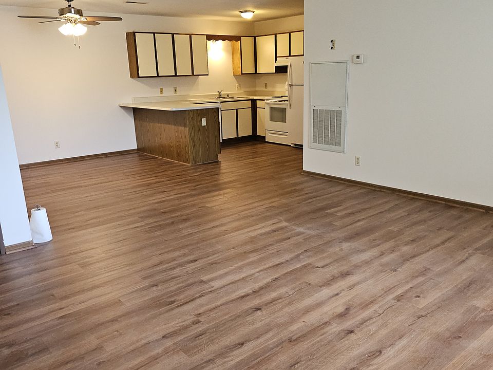 Living room view into the kitchen and dining room. All new plank flooring just installed.