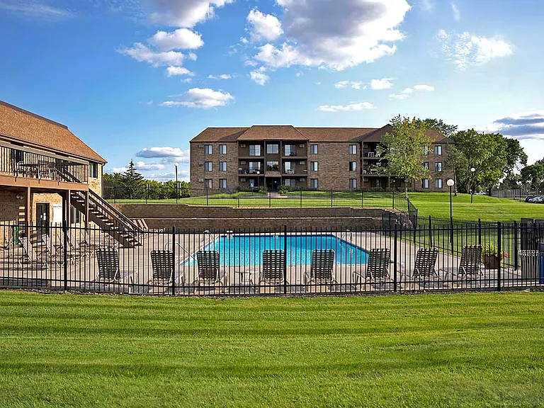 Heated outdoor pool with two-level sundeck and plenty of seating