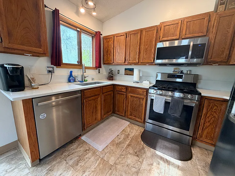 Stainless steel appliances, new floors, and countertops