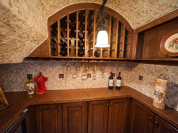 Wine cellar  with hand hammered copper countertops.