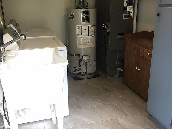 Utility Sink, Washer, Drier, Lots of shelving and even a pan