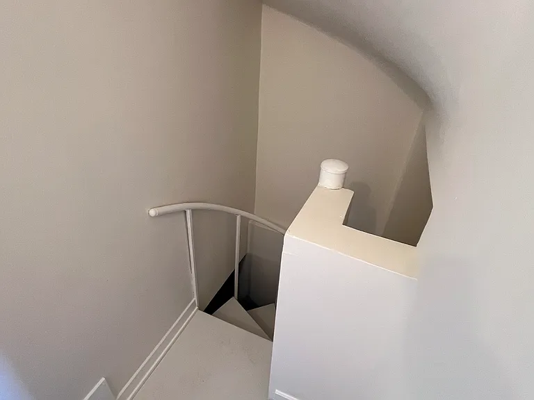 Spiral staircase in the front, steps in the back.