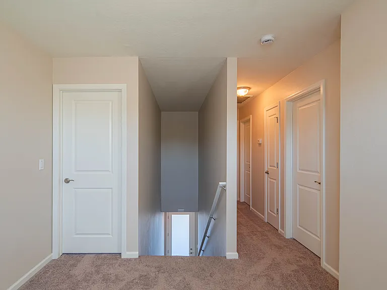 Upper level loft area, hallway to bedrooms and bathroom