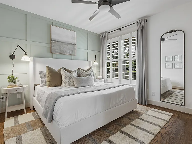 King sized bed in bedroom 2, featuring a walk-in closet, dresser, smart TV, full-length mirror, and ensuite bathroom.