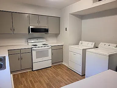 Microwave, dishwasher, refrigerator, washer, and dryer, garbage disposal.