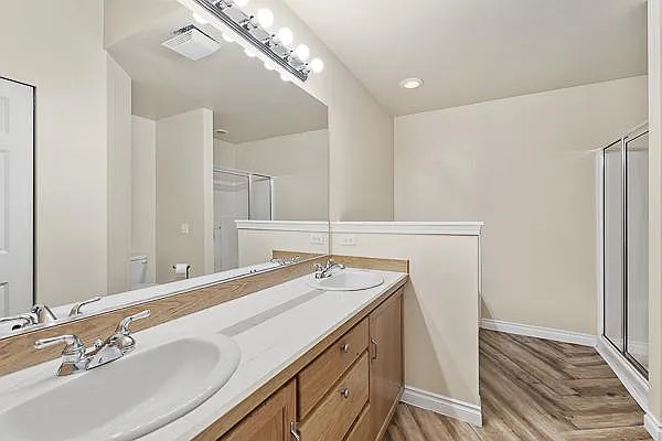 Primary bathroom with double sink, shower and tub.