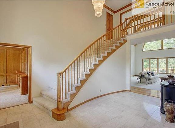 Airy and open foyer overlooks beautiful wall of windows in great room