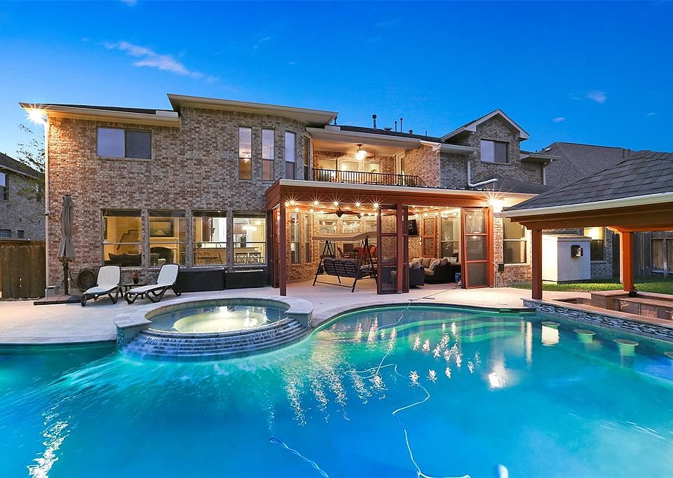 This Auburn Lakes resort style backyard is ready for a Houston summer! No need to travel far when this is your home!