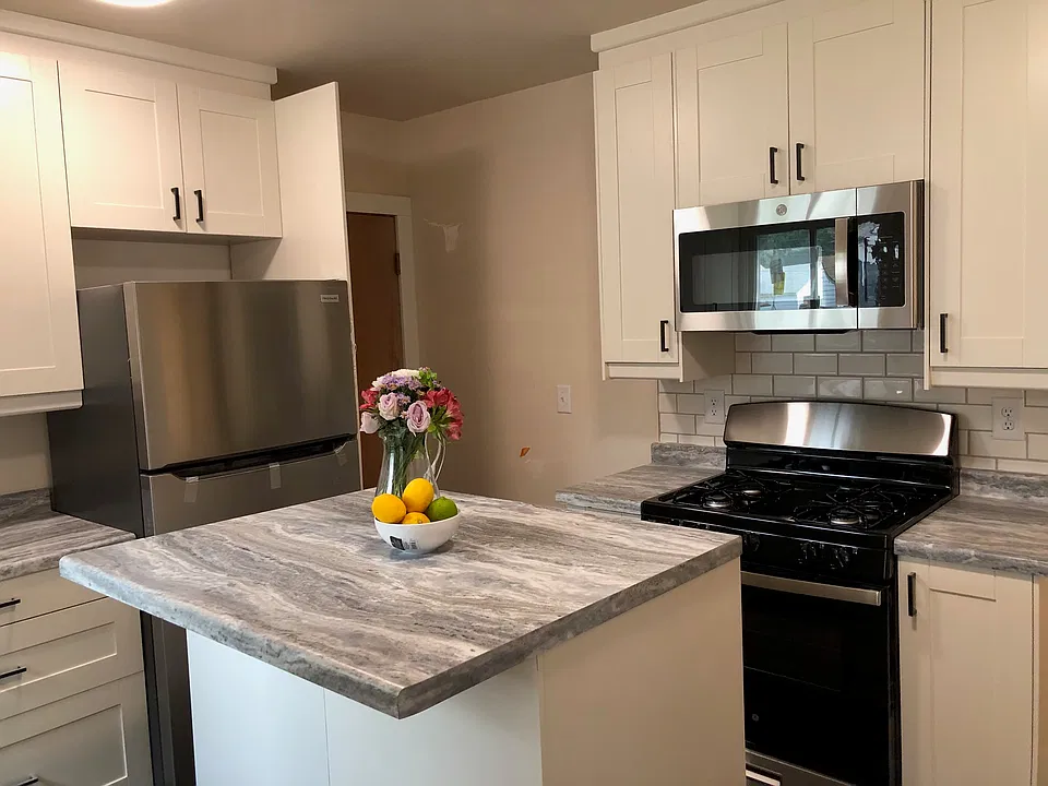 Kitchen with new appliances and tile backsplash, looking towards back door (basement access)