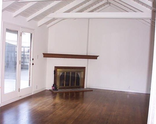 living room with open beam ceiling