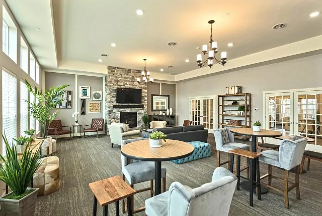 The community room offers comfortable seating in front of the fireplace