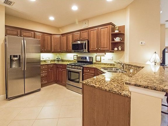 Newer Stainless Appliances, Gas Range, Wood Cabinetry,Granite counters, and Breakfast Bar.