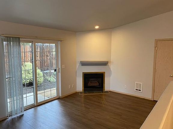 Living room has a fireplace and access to garden patio.