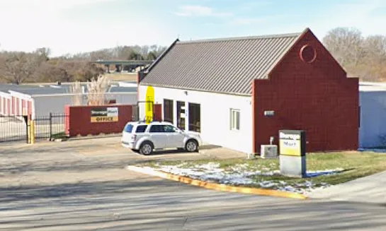 Apartment entrance is located behind gate (highlighted). Apartment is connected to an office (glass door).