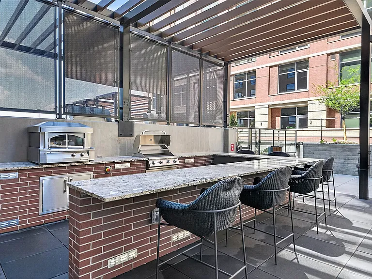Outdoor kitchen featuring grill and pizza oven