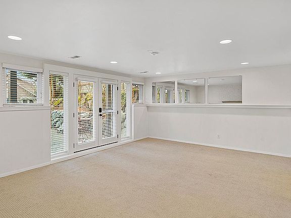 Main living area, looking northwest to the entrance. New carpet and LED lighting.