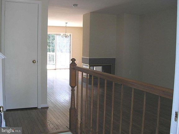 Walking into the front door. Living and dining room. Deck visible, closet door.