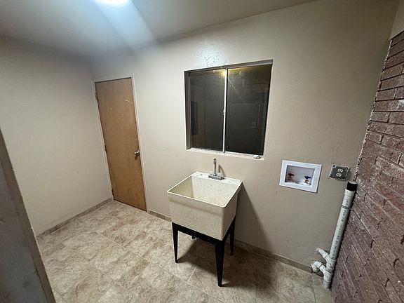 Laundry room with sink and water/dryer hookups.