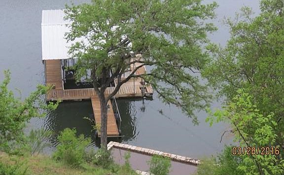 View of dock from patio, concrete steps to the dock
