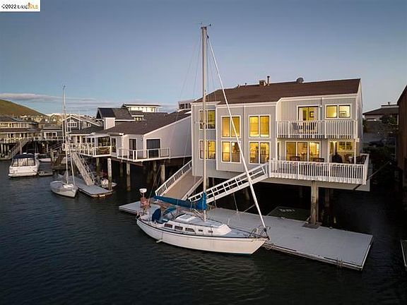 Backside of home with view of 60 ft dock.