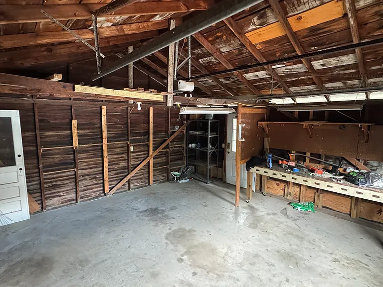 One car garage w lawn equipment, no mower