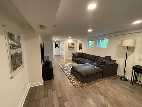 Finished basement with huge cloud couch and big screen TV with surround sound