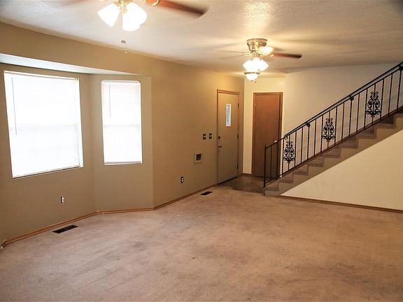 Living room showing front door, closet and stairway to master bedroom.
