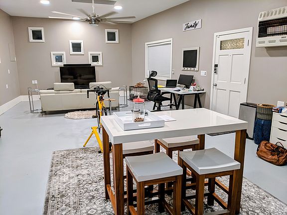 Interior of The Studio, with room for whatever you like. It has heat, two skylights, and a large ceiling fan. While it cannot be used as a garage, it does have a large garage door facing east. The door in the picture opens onto the deck.