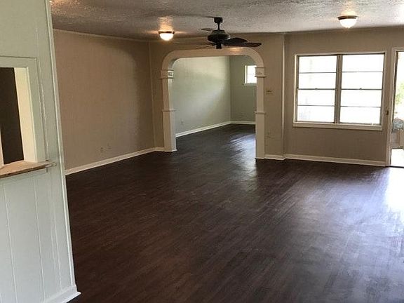View of the family room and living room before the new tile flooring and the January 2023 repainting. New pictures coming soon. Or, better yet, come see it!!