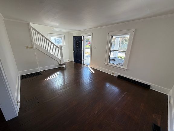 Living room features hardwood floors and has a cozy feel with windows on 3 sides