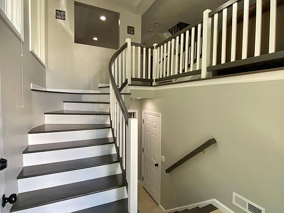 Entry foyer w/ stairs up to main level and stairs down to finished room in lower level and 2 car tandem garage.