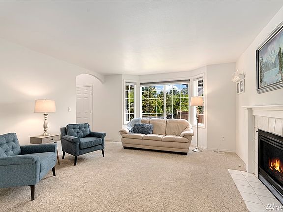 Formal living room with bay window and gas fireplace.