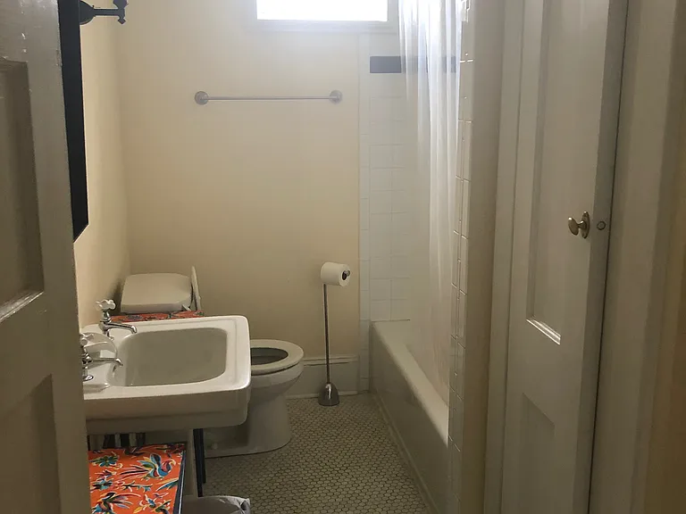 Bathroom with closet, 2 sconce lights on each side of the sink, and 2 side tables with drawers.
