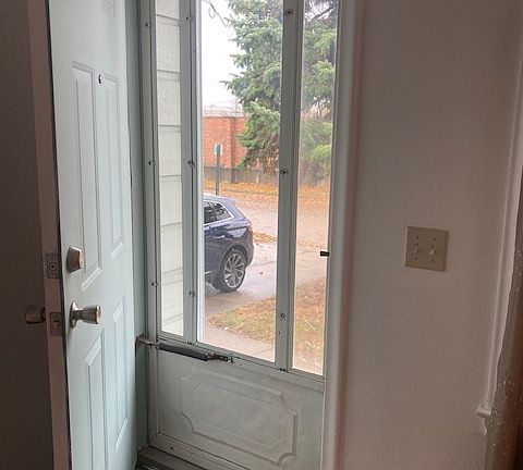 Front door leading from living room to outside.