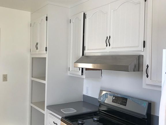 Newly remodeled kitchen, gas range, quartz counter tops, tile floors, and new ceiling lighting