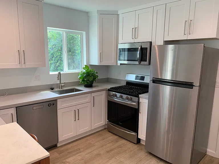 Kitchen with new counter tops and appliances.