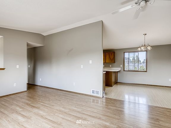 Easy transition from living room to kitchen with nice neutral paint tones. Large Milgard window overlooking rear yard.