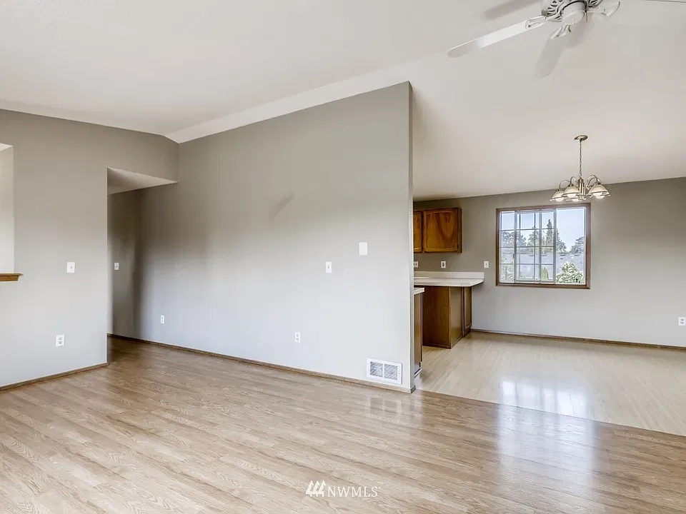 Easy transition from living room to kitchen with nice neutral paint tones. Large Milgard window overlooking rear yard.