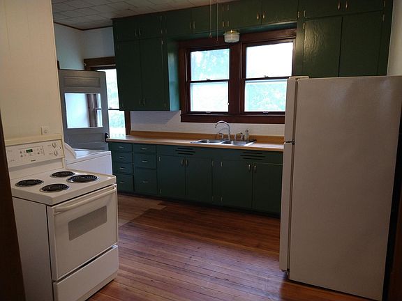 View of the kitchen while standing in the hallway.