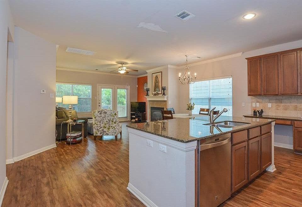 Plenty of windows and french doors open to a green space, deck, and rock flagstone private retreat. Open concept high ceilings with extra large island with breakfast sitting, dining room and family room combo!