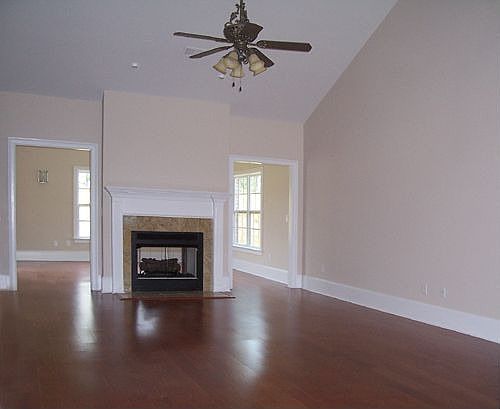 Living Room with fireplace, hardwood floors and valuted ceiling