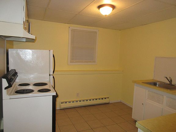 Kitchen with range and refrigerator