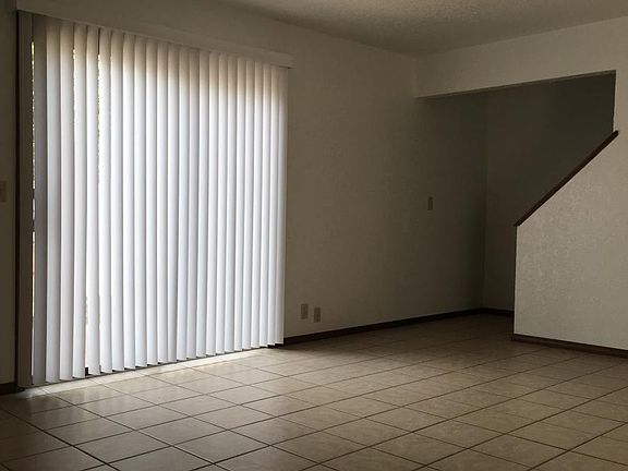 Living Room - ceramic tile, sliding door to fenced yardd